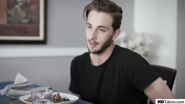 Flirty blondie guy sits at table in threesome setup with bf and damsel