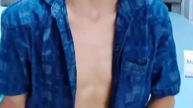Young Asian male in open blue shirt exposing bare chest on webcam