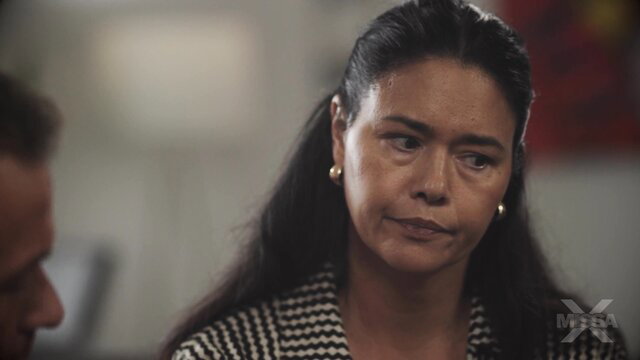 Stunning mature Latina in checkered blouse, serious gaze, 4K thumbnail