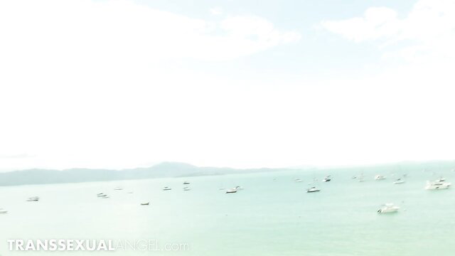 Sabrina Suzuki TS in teal sea with boats, huge tits & BBW ass