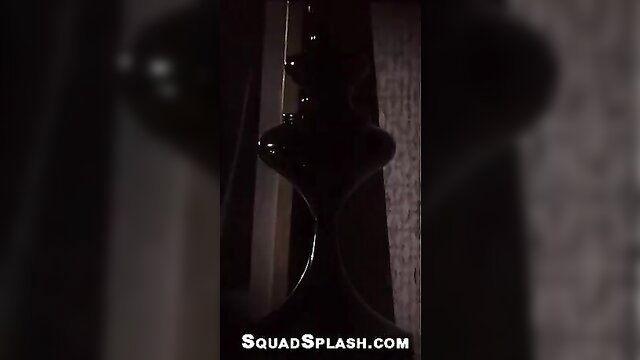 Nikky Thorne closeup of glossy black vase-shaped object in dim room