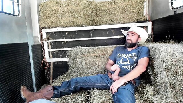 Hot cowboy asleep on hay bales, hand down jeans bulge exposed