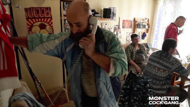 Bald bearded man in retro shirt on phone in Monster Cock Gang husband shares wife scene