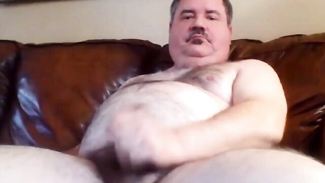 Bearded fat dad bear stroking fat cock on couch