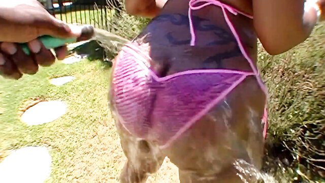 Cherokee D'Ass thick black ass hosed down in pink thong bikini outdoors