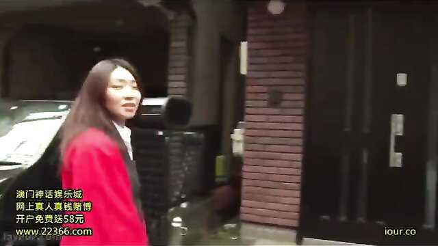 Asian MILF in red coat and white blouse outside house door