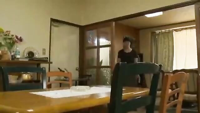 Japanese woman in black dress at table in pervert family JAV scene