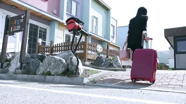 Korean MILF in black abaya drags red suitcase outdoors in My Students Mom 3