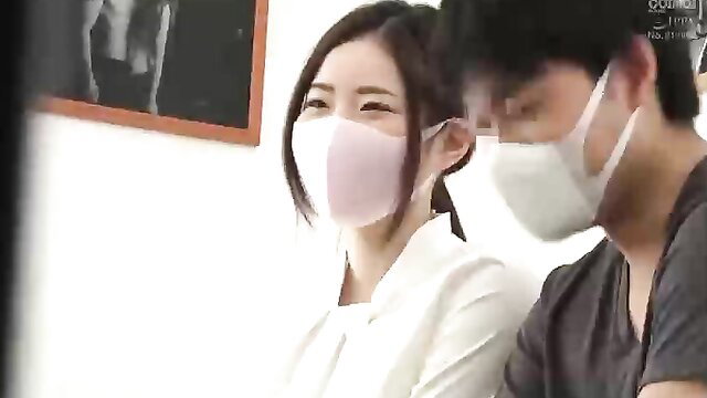 Asian couple in masks close-up flirty smiles softcore tease