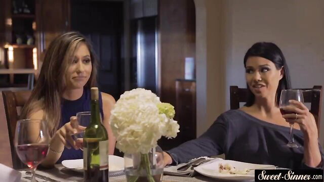 Two busty stepmoms with wine glasses at table, lesbian tease