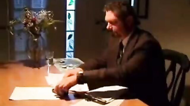 Handsome bearded man in suit at table in erotic step bro scene