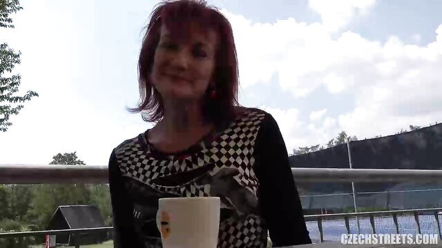 Redhead Czech MILF in checkered top sips coffee outdoors on balcony