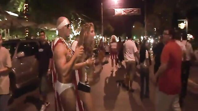 Bald white hunk in speedo and lei dances at wild Spring Break party