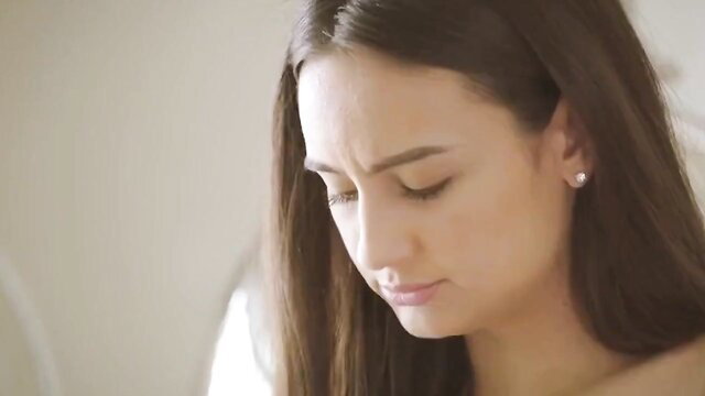 Closeup of thoughtful brunette teen with pearl earrings