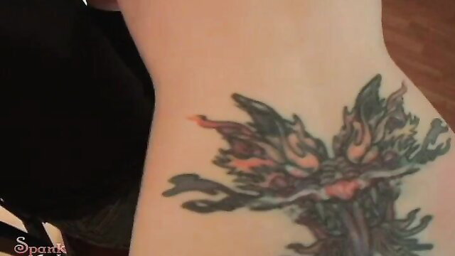 Closeup of woman's pale neck and winged tattoo during Amber spanked scene