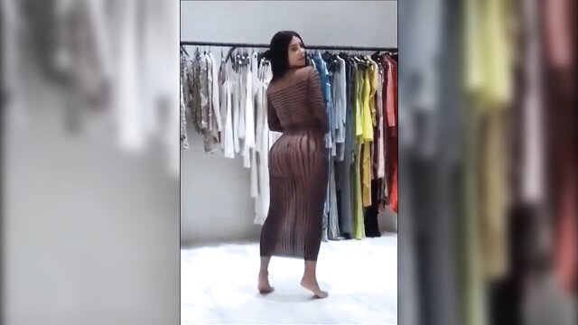 Curvy black woman in sheer mesh dress twerking in clothing store