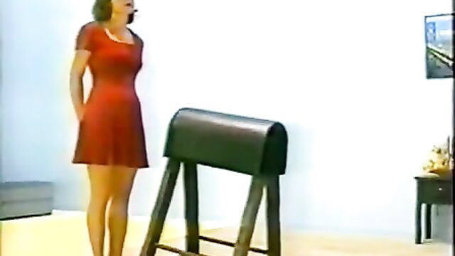 Bound skinny teen in red dress by punishment bench