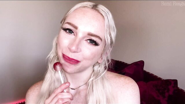 Remi Reagan licks red lollipop seductively in porn face fetish JOI