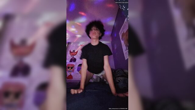 Afro-haired twink diaper boy posing in bulging diaper, purple room glow