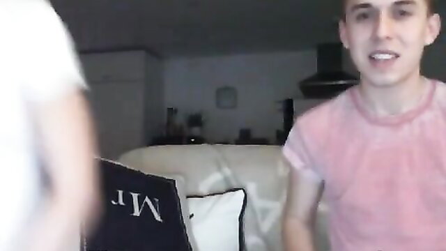 Young twink guy smiling on webcam in pink tee, amateur fun