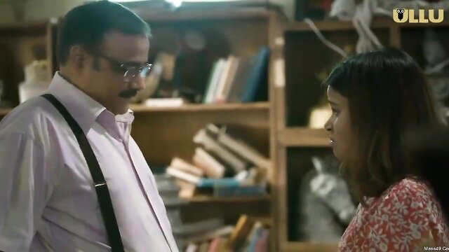 Indian man in shirt suspenders talks to busty desi woman in floral dress closeup