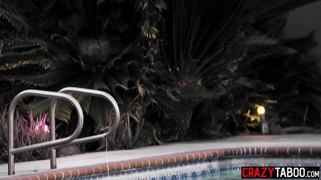 Night poolside steps with lush plants and neon glow