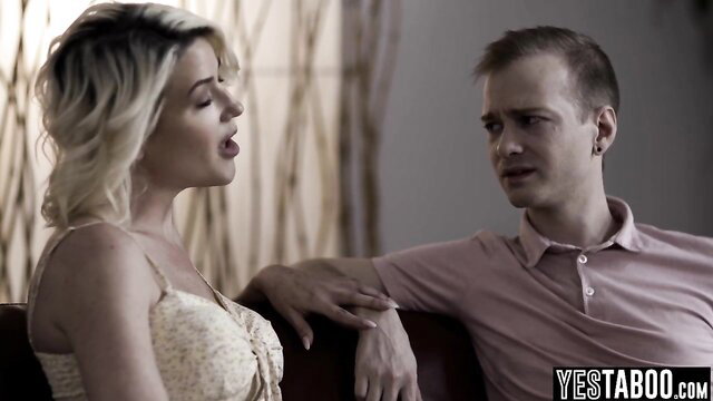 Buxom blonde wife chats intimately with stepson on couch