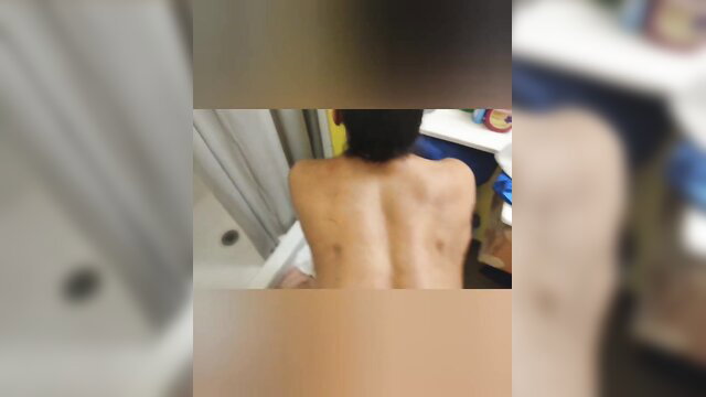 Skinny Asian guy nude in shower, bare back view from amateur gay porn