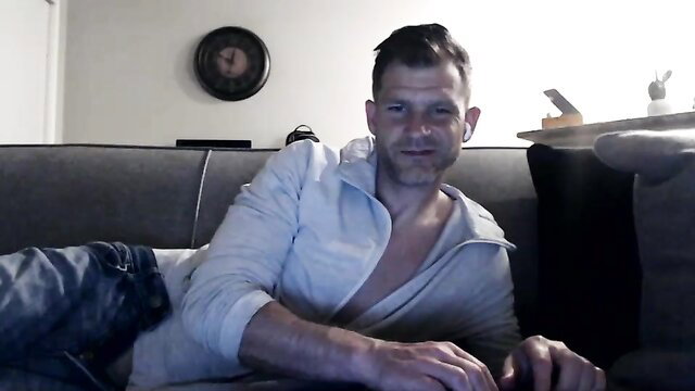 Hot white guy lounging shirtless on couch in unbuttoned shirt