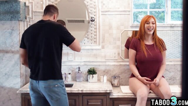 Lauren Phillips redhead stepmom sitting on sink, guiding stepson in bathroom