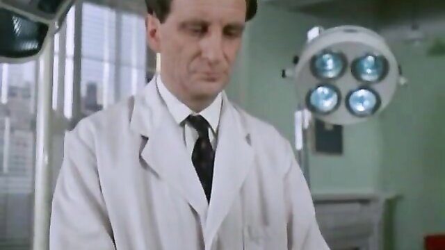 Brainwash in white lab coat under surgical lights, intense doctor stare