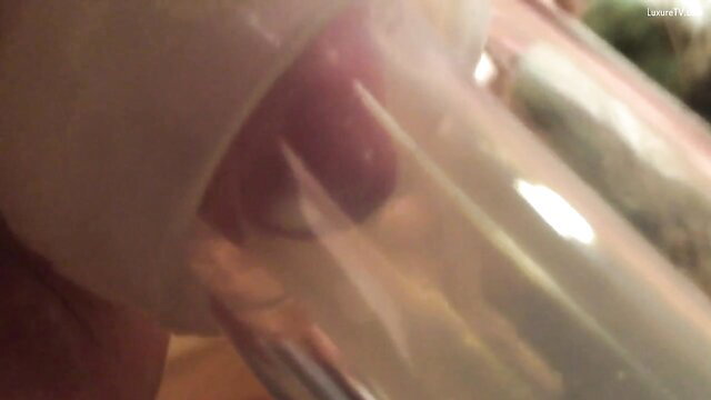 Closeup of woman milking huge lactating tits like a cow into glass