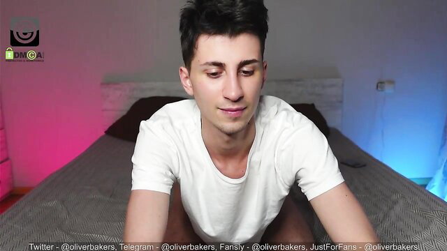Oliver Baker shirtless on bed in Chaturbate gay cam show