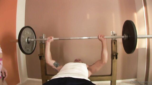 Scott Stone bench pressing weights shirtless in gym