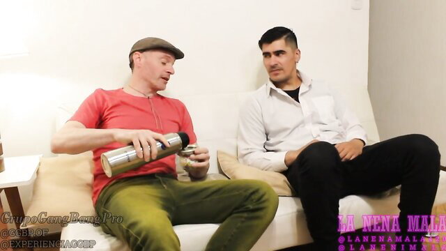 Two men on couch, one pouring drink, cuckold setup betrayal thumbnail