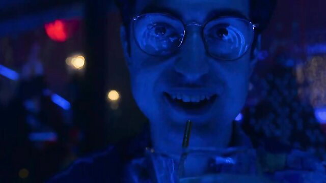 Veronica Sanchez smiling seductively in neon-lit Sky Rojo club scene