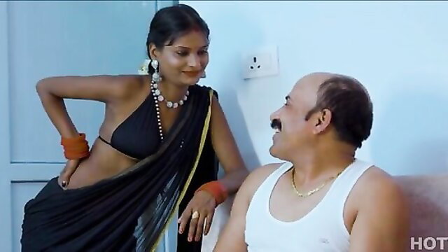 Indian bhabhi in black saree and blouse teases bald man on couch