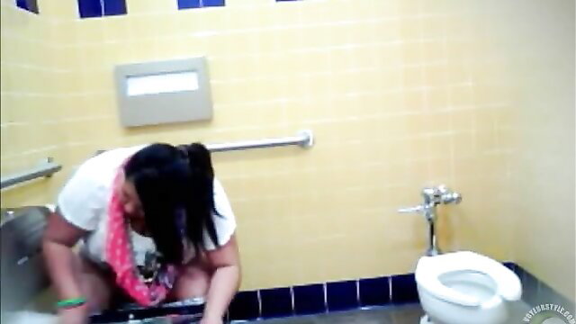 Chubby Latina in white tee squats to pee in public toilet with friend