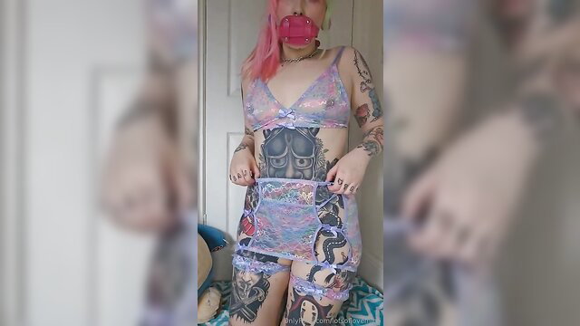 Kinky amateur girl in pink lingerie shows perky tattooed tits, ball gag
