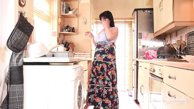 Busty mom in floral dress flashes tits in kitchen solo tease