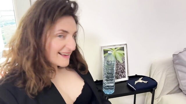 Lila's smiling brunette cleavage in deep black blazer lingerie