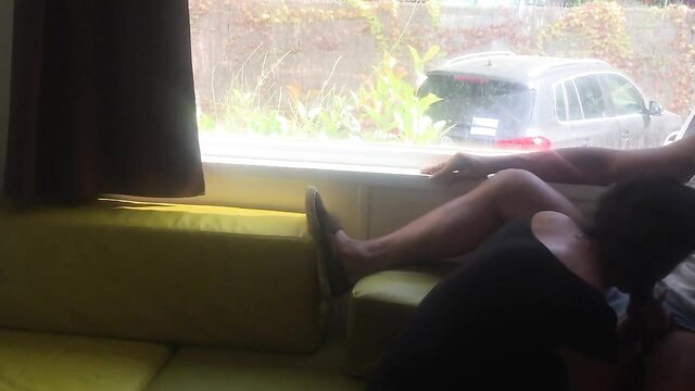 Amateur couple risky public blowjob on yellow couch by open window