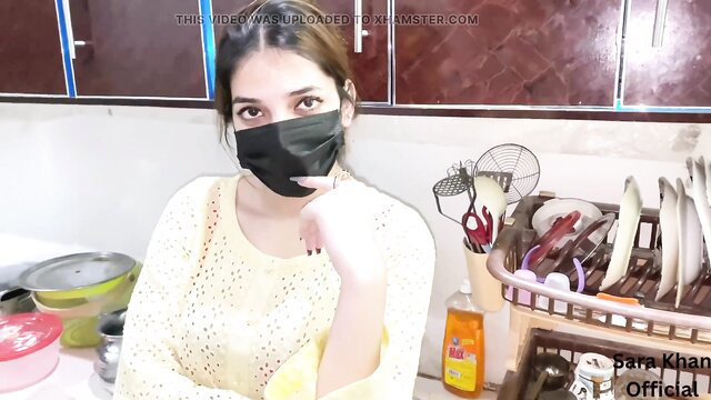 Desi girl Bara Khan in mask and sweater poses sexy in kitchen