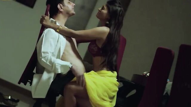 Indian couple hot embrace, busty brunette in bra and saree on lap