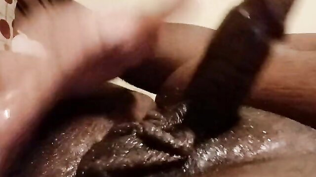Ebony woman feetjob with oiled black cock closeup