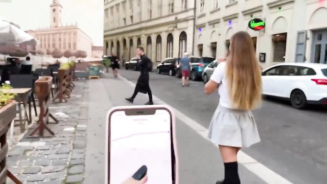 Blonde stepsister in schoolgirl skirt controlled by Lovense Lush toy in public street