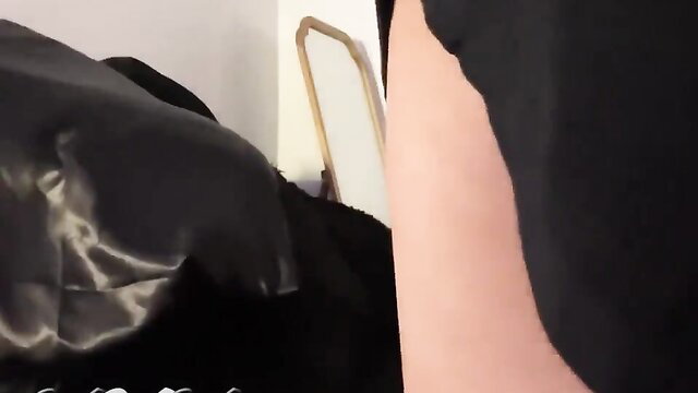 Sasha Strokes shemale in black lingerie by mirror on bed