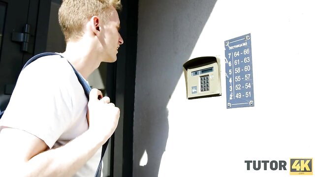 Blond stud eyes keypad at door with tutor label in hot 4K preview