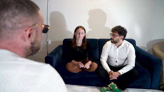 Annie Charlotte sits with man on couch in tense interview, 29 yrs older