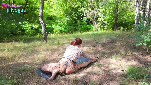 Redhead in fishnet bodysuit does outdoor yoga, big ass stretch